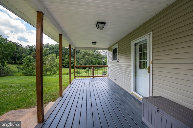 wooden terrace with a lawn