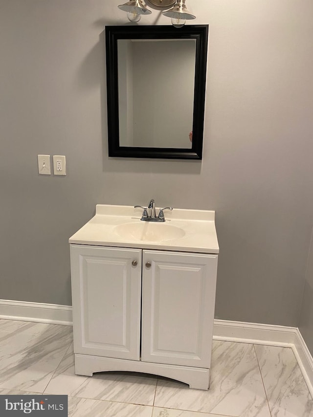 bathroom featuring marble finish floor, baseboards, and vanity