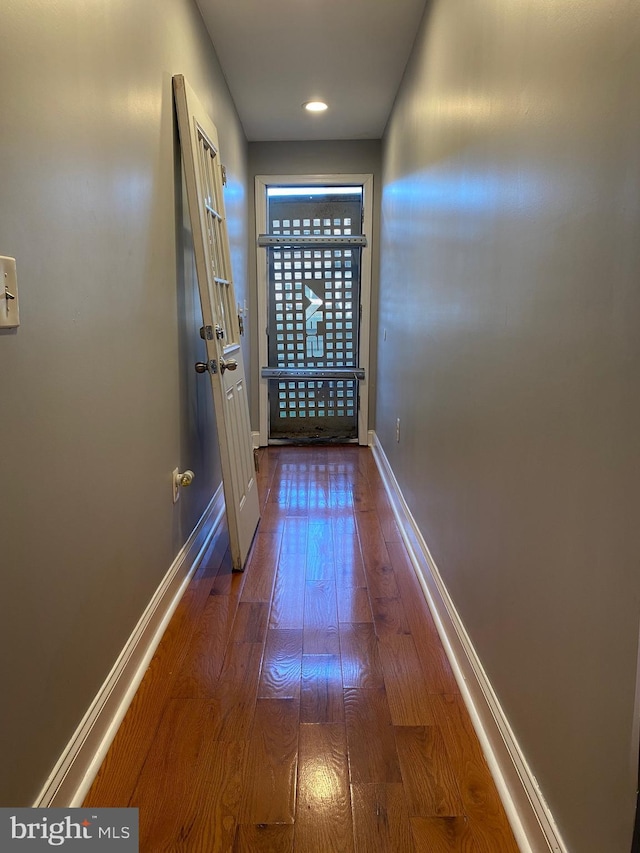 entryway with baseboards and wood finished floors