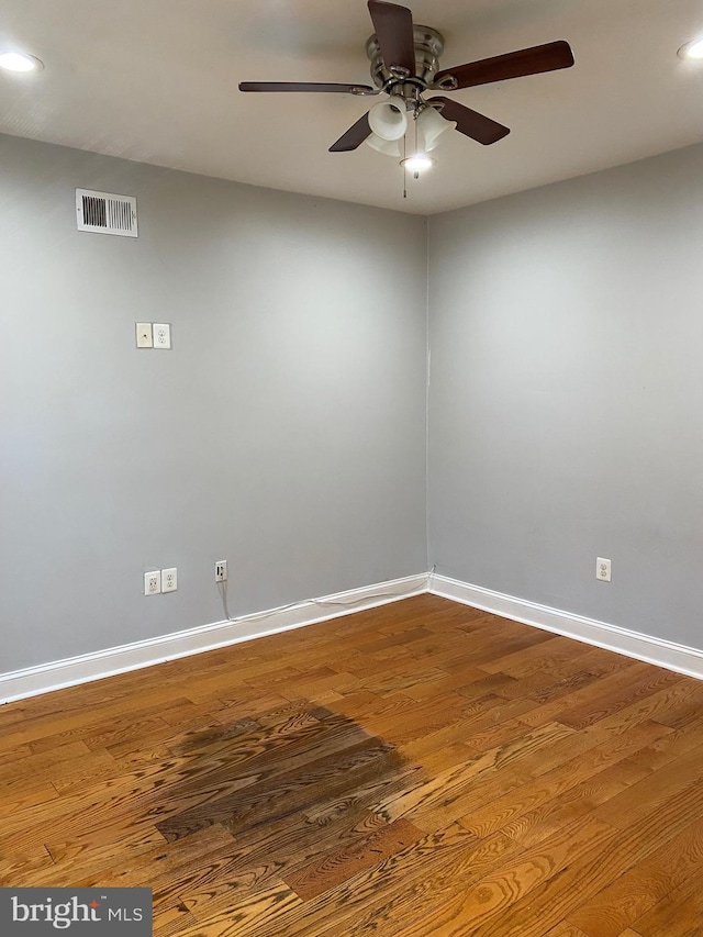 unfurnished room with hardwood / wood-style flooring and ceiling fan