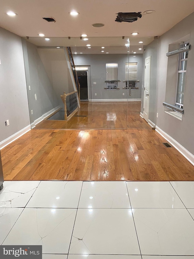 interior space with visible vents, baseboards, and tile patterned floors