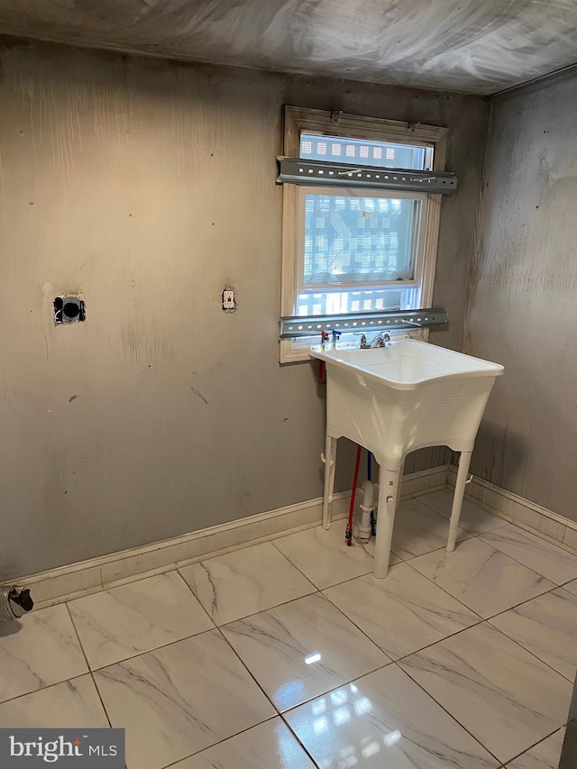 interior space featuring marble finish floor and baseboards