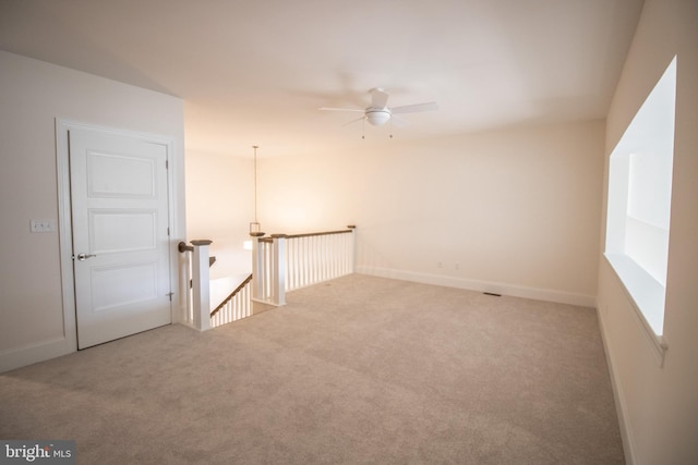 carpeted empty room featuring ceiling fan