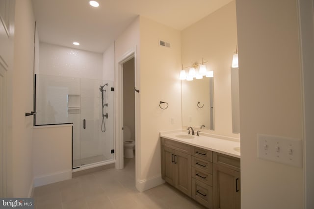 bathroom with vanity, toilet, and a shower with shower door