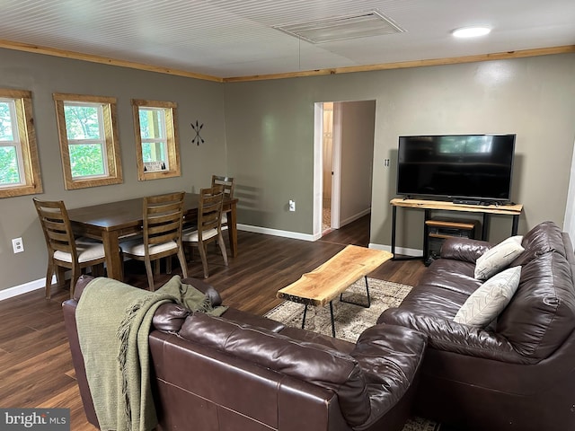 living room with dark hardwood / wood-style floors and crown molding