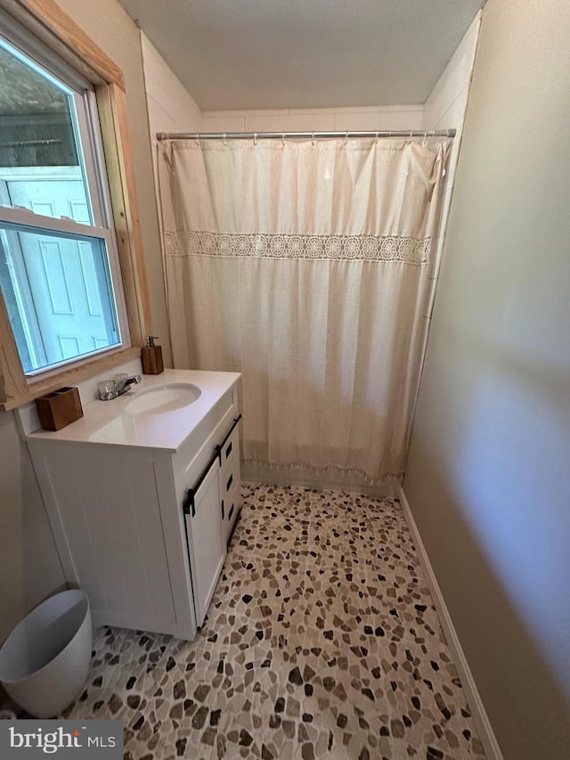 bathroom with vanity and curtained shower