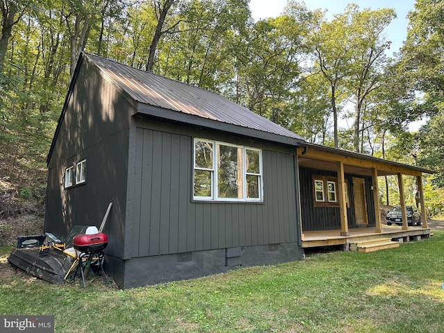 view of home's exterior featuring a wooden deck and a lawn