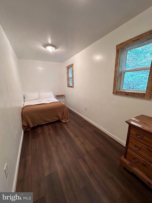 unfurnished bedroom with dark hardwood / wood-style flooring