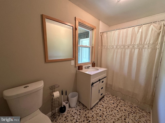 bathroom featuring toilet, vanity, and tile patterned floors