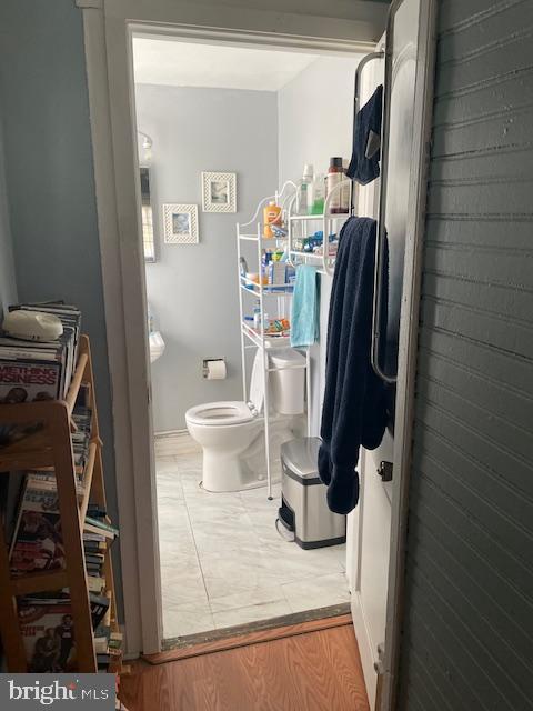 bathroom featuring wood-type flooring and toilet