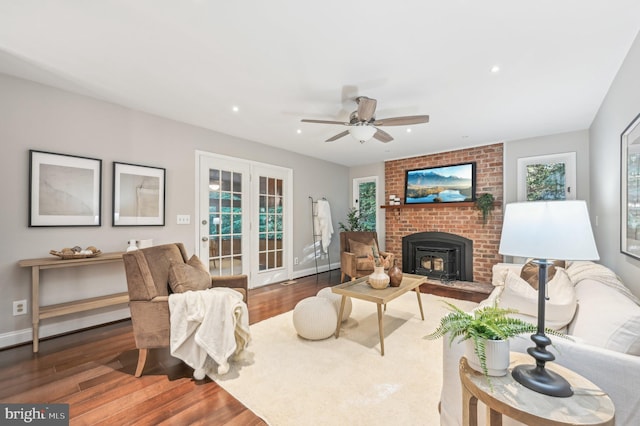 living room featuring ceiling fan and dark hardwood / wood-style flooring