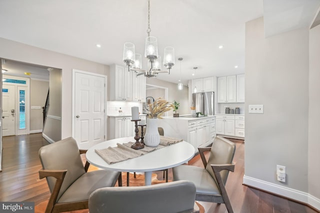 dining area featuring a notable chandelier and dark hardwood / wood-style flooring