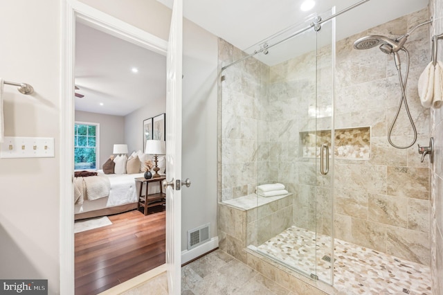 bathroom featuring walk in shower and wood-type flooring