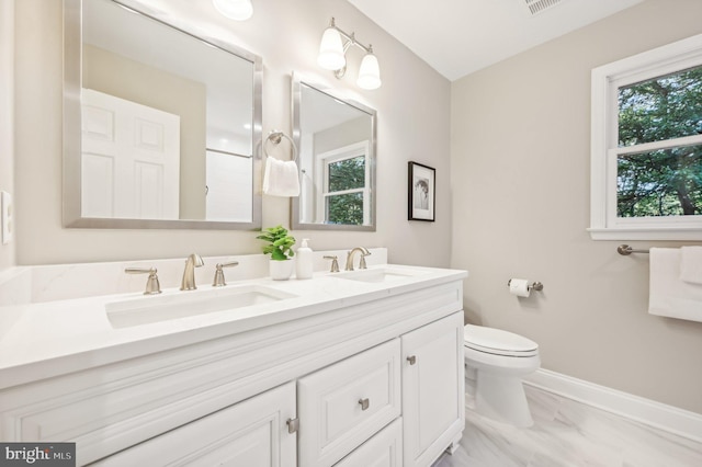 bathroom featuring vanity and toilet