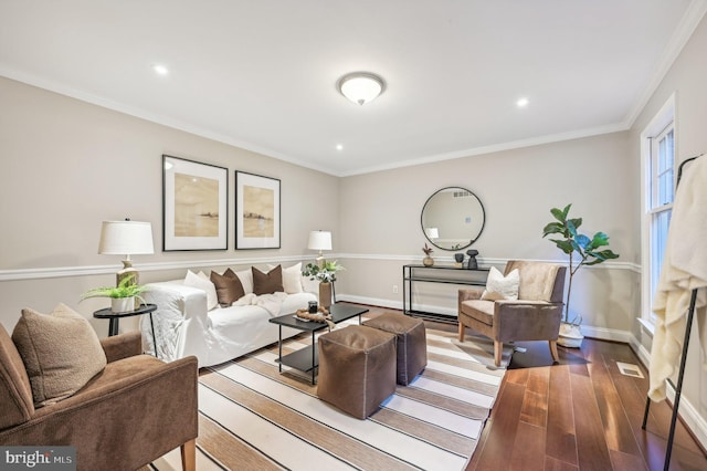 living room with crown molding and hardwood / wood-style floors