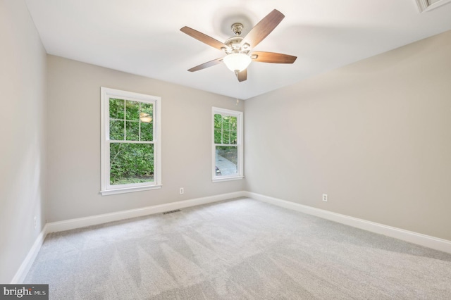 spare room featuring ceiling fan and carpet floors