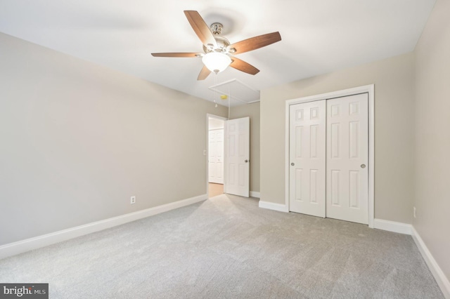 unfurnished bedroom with light carpet, ceiling fan, and a closet