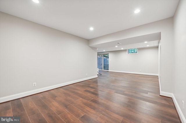 empty room with dark hardwood / wood-style flooring