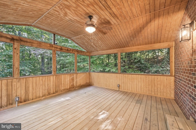 unfurnished sunroom with a wealth of natural light, vaulted ceiling, and wood ceiling