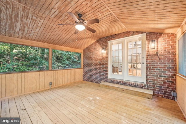 unfurnished sunroom with ceiling fan, vaulted ceiling, and wood ceiling