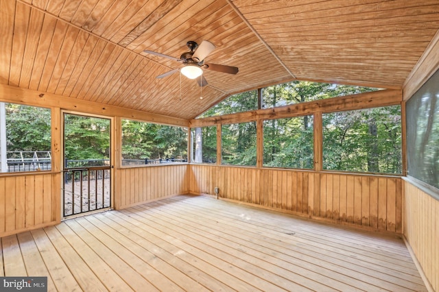 unfurnished sunroom with plenty of natural light, wooden ceiling, and ceiling fan