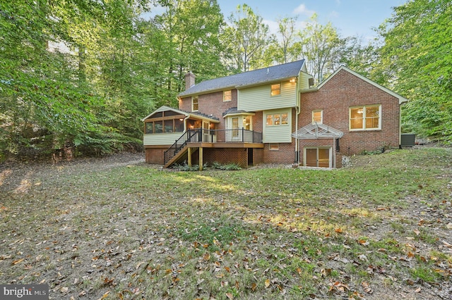 rear view of property with a gazebo, cooling unit, a sunroom, and a deck