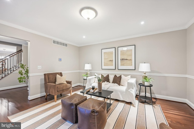 living room featuring a chandelier, crown molding, and dark hardwood / wood-style flooring