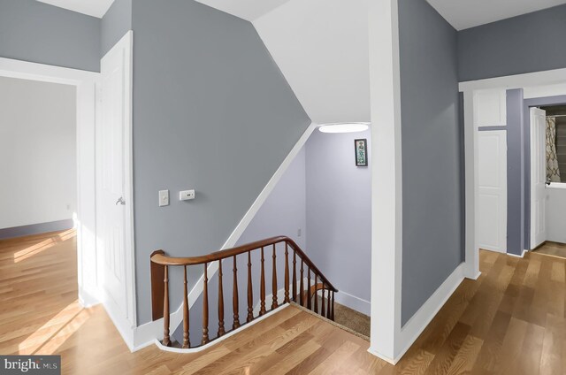 stairs featuring hardwood / wood-style floors