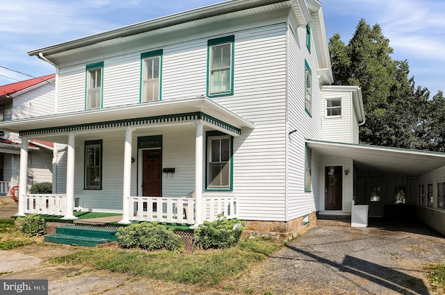 view of front of property with a carport and covered porch