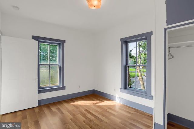 unfurnished bedroom with a closet and wood-type flooring