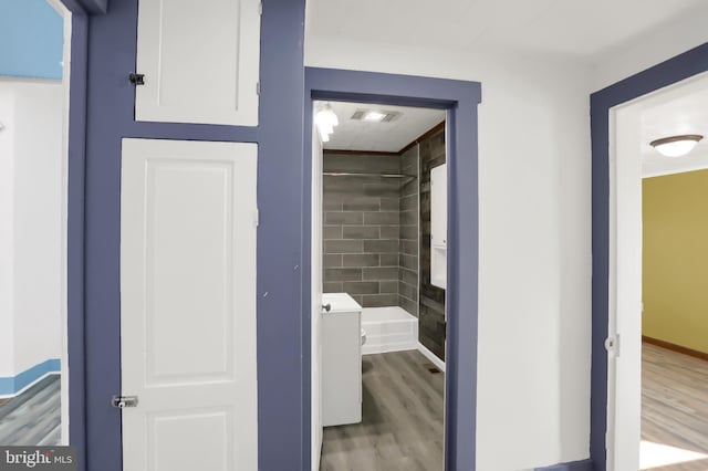 hallway with hardwood / wood-style flooring