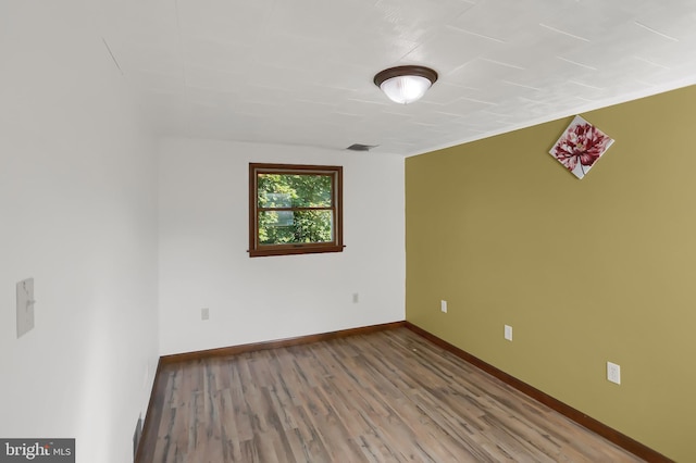 spare room with hardwood / wood-style flooring