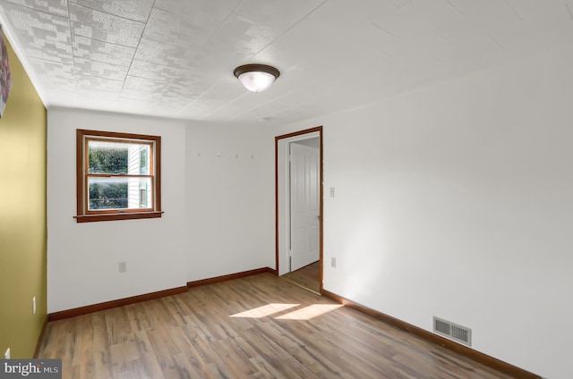 spare room featuring light hardwood / wood-style flooring