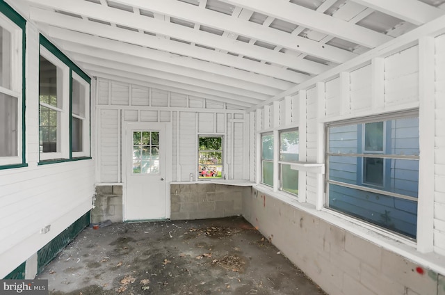 unfurnished sunroom with lofted ceiling