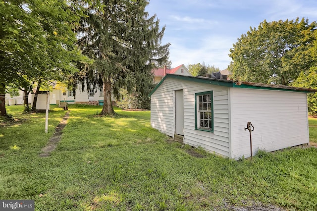 view of outbuilding with a lawn