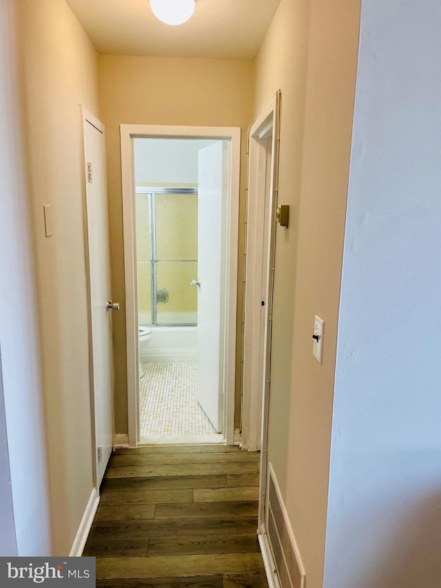 corridor featuring dark hardwood / wood-style floors