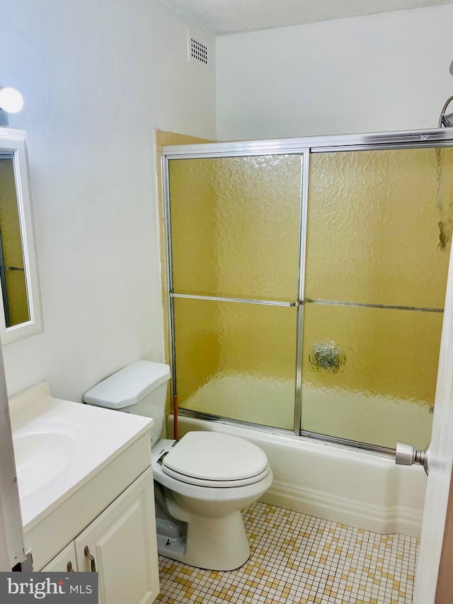 full bathroom with tile patterned flooring, toilet, enclosed tub / shower combo, and vanity