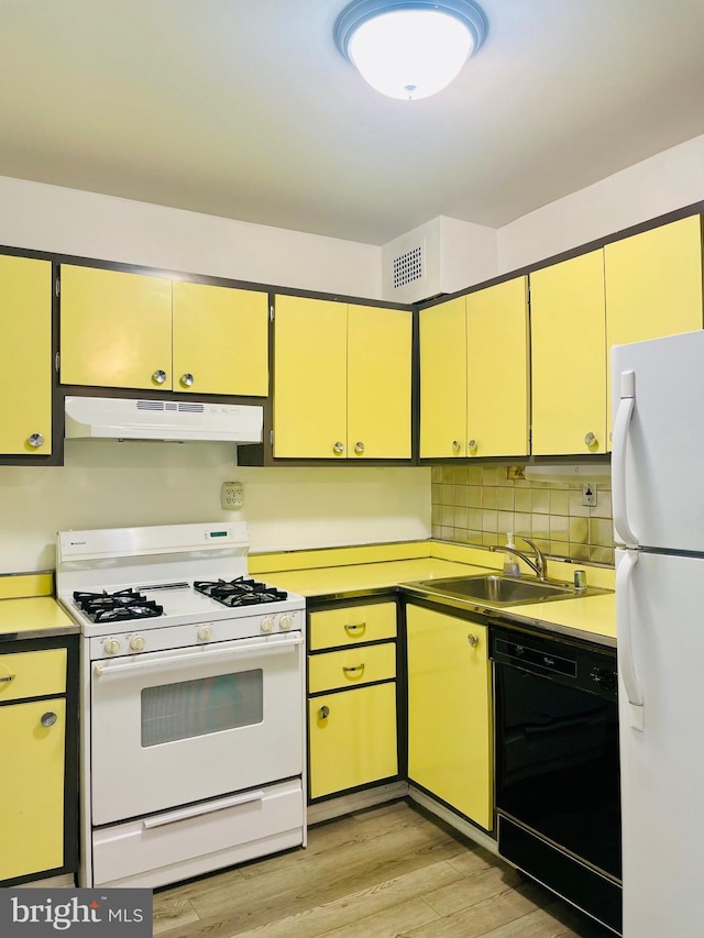 kitchen with light hardwood / wood-style flooring, sink, white appliances, and decorative backsplash