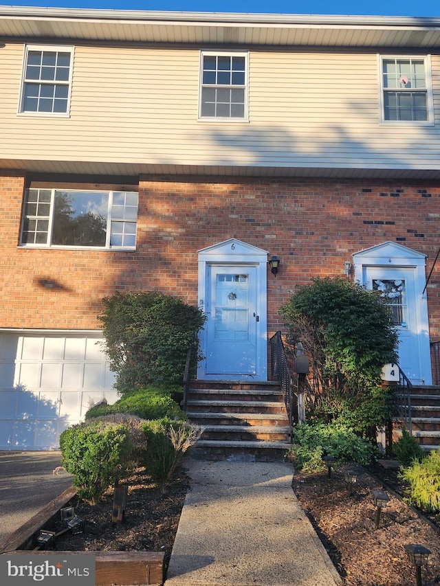 view of front of property featuring entry steps and brick siding