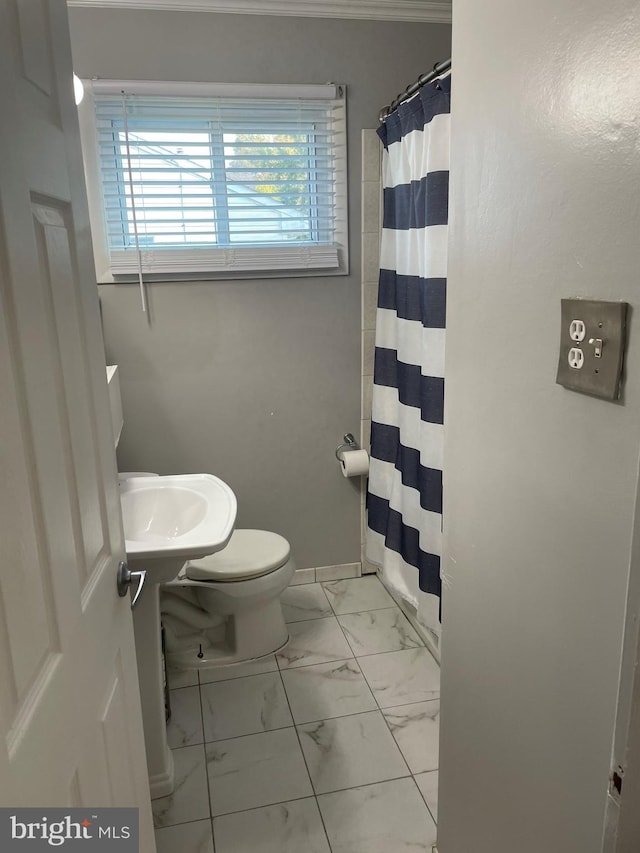 bathroom with sink, toilet, and curtained shower