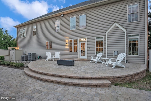 rear view of house featuring a patio area and cooling unit