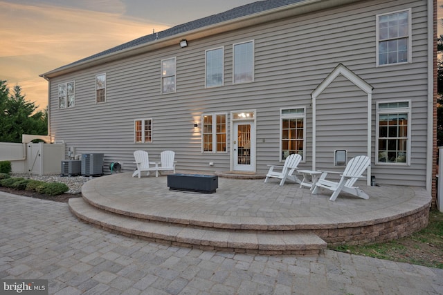 back house at dusk with a patio