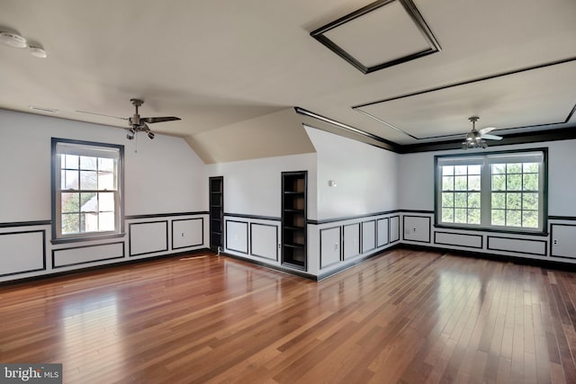 empty room featuring hardwood / wood-style flooring, a healthy amount of sunlight, and ceiling fan