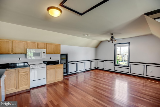 kitchen with light brown cabinets, vaulted ceiling, dark wood-type flooring, white appliances, and ceiling fan