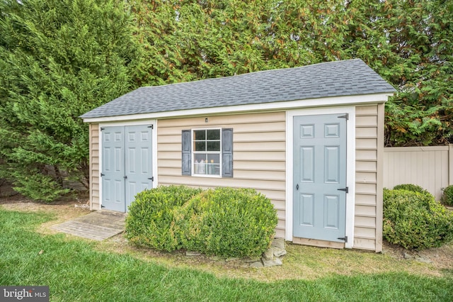 view of outbuilding featuring a yard