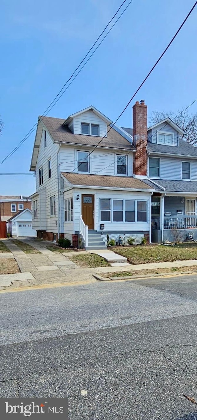 multi unit property featuring an outdoor structure and a chimney