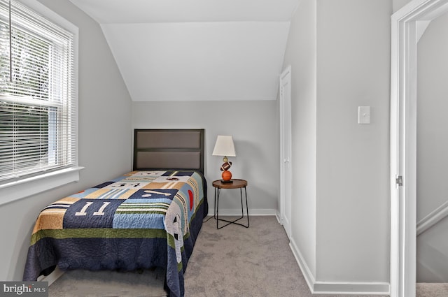 carpeted bedroom with vaulted ceiling