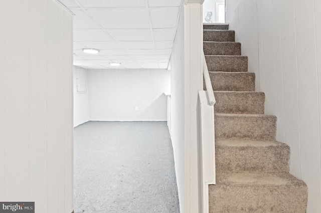 staircase featuring a paneled ceiling