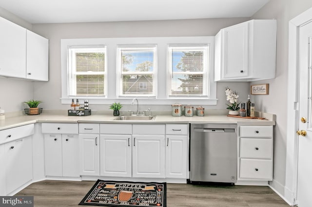 kitchen with light wood-type flooring, dishwasher, white cabinetry, and sink