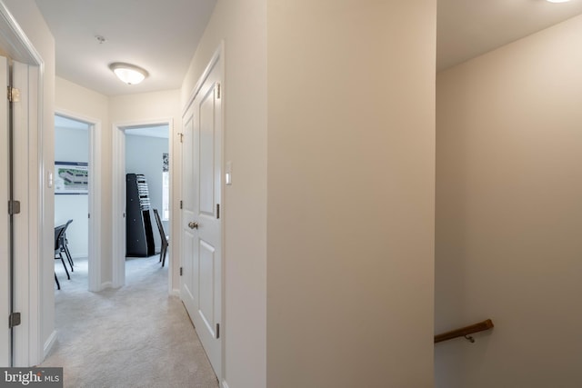 hallway featuring light colored carpet